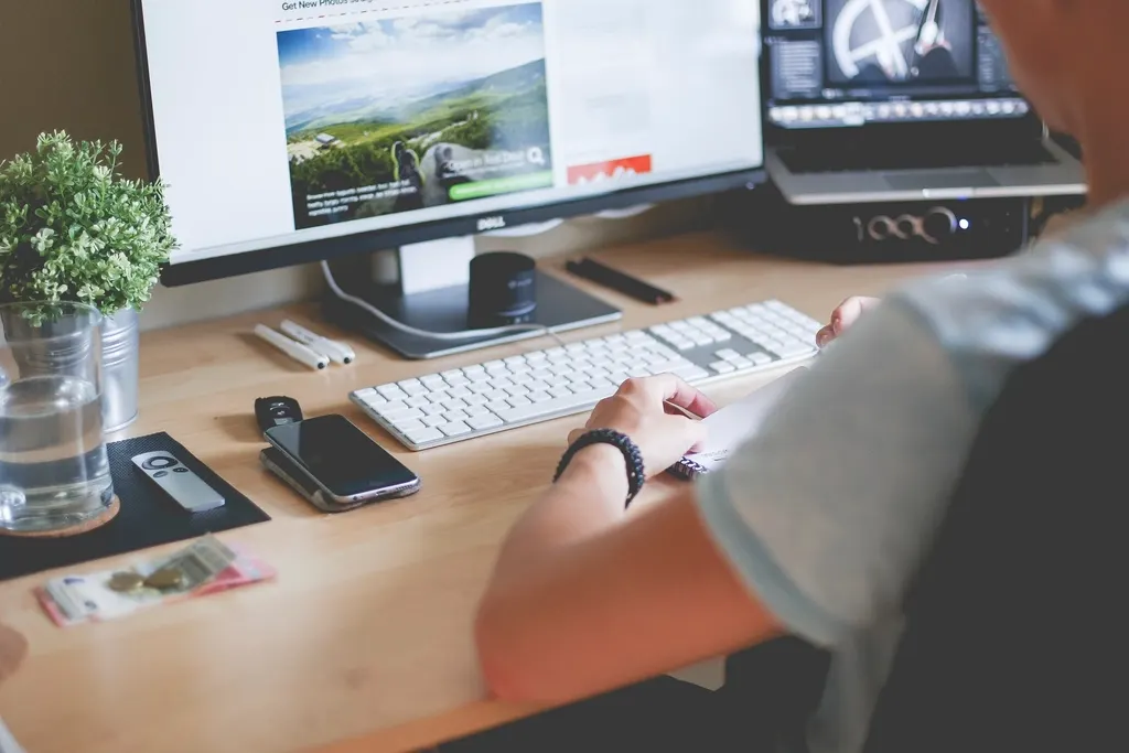 Call to action on a website: a person using a mouse and keyboard at a desktop computer