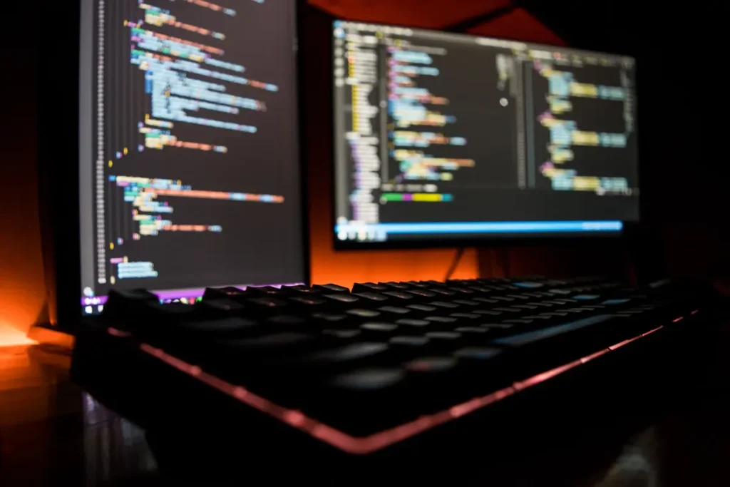 Staging site work in progress with website code open across two monitors
